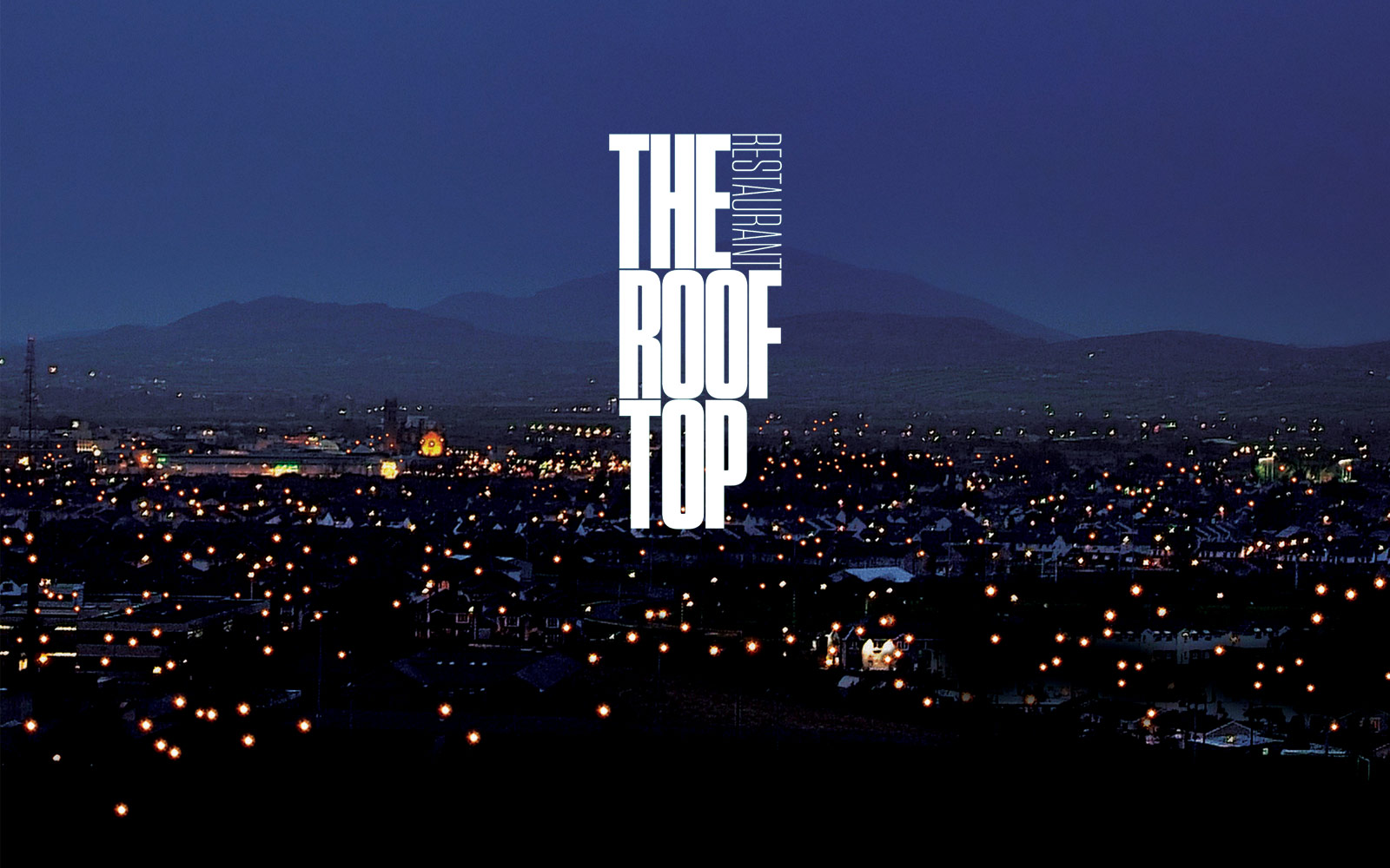 Rooftop Restaurant logo against night sky